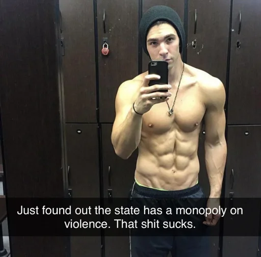Selfie taken in a locker room. The subject is a muscular man wearing a beanie and gym shorts, a typical gym bro. The text overlay reads: "Just found out the state has a monopoly on violence. That shit sucks."